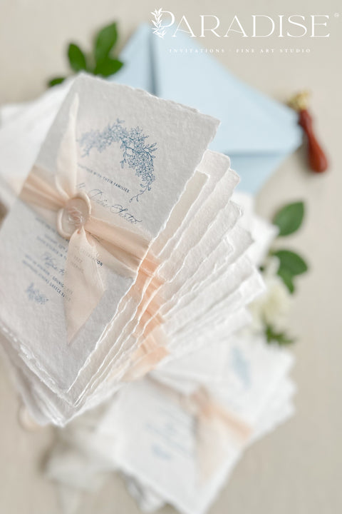 Announce your seaside celebration with these beautifully crafted handmade paper wedding invitations. Perfect for a beach wedding, this suite combines a relaxed, coastal feel with the refined elegance of artisan cotton rag paper. Each invitation features a delicate botanical design that evokes the natural beauty of the shoreline, from swaying palms to coastal foliage. The unique, deckled-edge paper adds a rustic, organic texture that is perfectly suited for a romantic oceanfront ceremony.