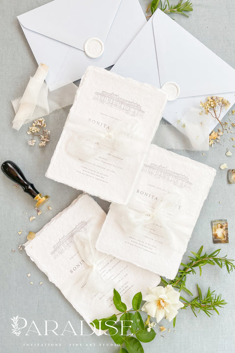 Announce your wedding with timeless sophistication through this handmade paper wedding invitation suite, featuring a hand-drawn illustration of your wedding venue - a keepsake that beautifully captures the heart of your celebration. Printed on luxury deckled-edge cotton paper. Wrapped softly with sheer ivory ribbon and paired with powder-blue envelopes sealed with wax, this suite balances elegance and sentiment, making every detail feel intentional and romantic.