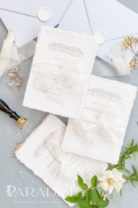 Announce your wedding with timeless sophistication through this handmade paper wedding invitation suite, featuring a hand-drawn illustration of your wedding venue - a keepsake that beautifully captures the heart of your celebration. Printed on luxury deckled-edge cotton paper. Wrapped softly with sheer ivory ribbon and paired with powder-blue envelopes sealed with wax, this suite balances elegance and sentiment, making every detail feel intentional and romantic.