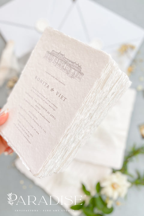 Announce your wedding with timeless sophistication through this handmade paper wedding invitation suite, featuring a hand-drawn illustration of your wedding venue - a keepsake that beautifully captures the heart of your celebration. Printed on luxury deckled-edge cotton paper. Wrapped softly with sheer ivory ribbon and paired with powder-blue envelopes sealed with wax, this suite balances elegance and sentiment, making every detail feel intentional and romantic.