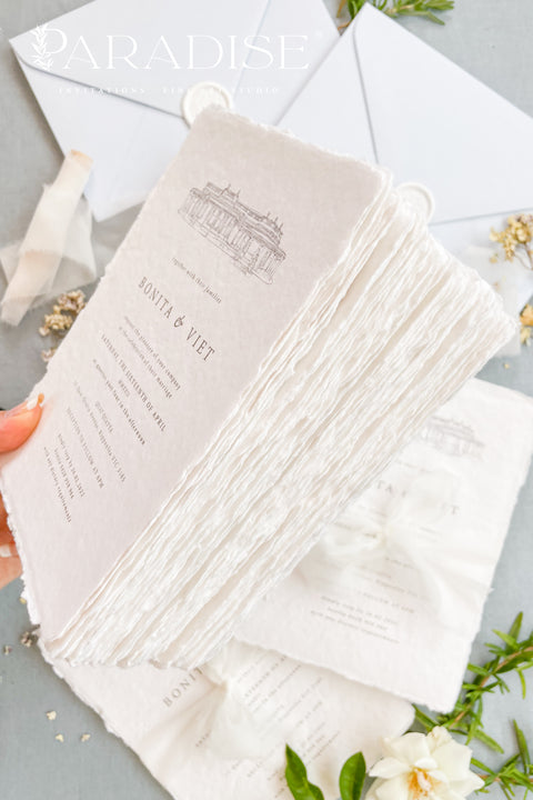 Announce your wedding with timeless sophistication through this handmade paper wedding invitation suite, featuring a hand-drawn illustration of your wedding venue - a keepsake that beautifully captures the heart of your celebration. Printed on luxury deckled-edge cotton paper. Wrapped softly with sheer ivory ribbon and paired with powder-blue envelopes sealed with wax, this suite balances elegance and sentiment, making every detail feel intentional and romantic.