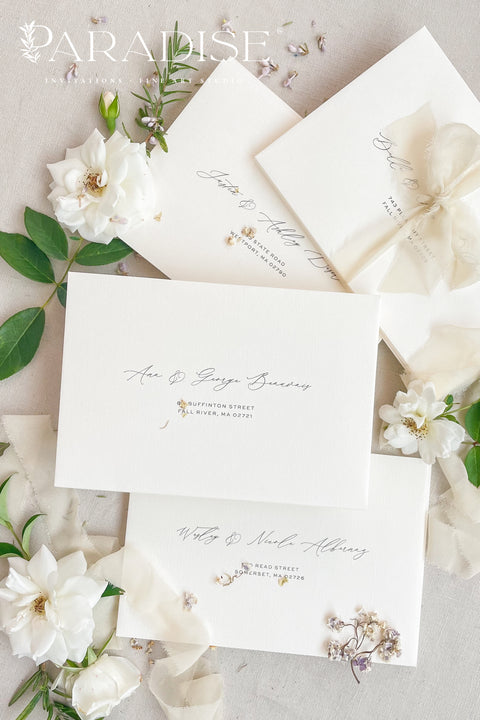 Stack of coco linen envelopes with address printing displaying consistent color, textured paper surface, and structured luxury wedding stationery finish.