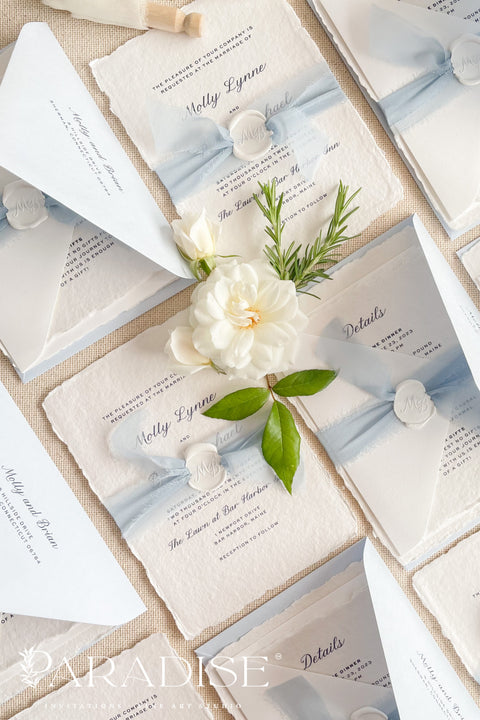 Elegant, romantic, and handmade with love - our fine art wedding invitation suite is crafted from luxury cotton deckled-edge paper and finished with a delicate powder blue chiffon ribbon and white wax seal. The soft blue tones and artisanal textures make this suite perfect for fine art, coastal, or destination weddings, offering a serene yet refined aesthetic that feels effortlessly graceful.