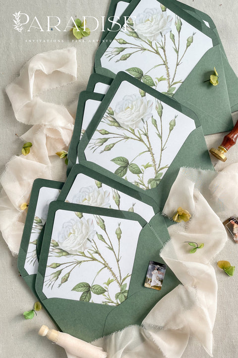 Soft green envelopes featuring floral liners, photographed open to reveal botanical artwork, ideal for elegant wedding invitations and fine-art stationery.