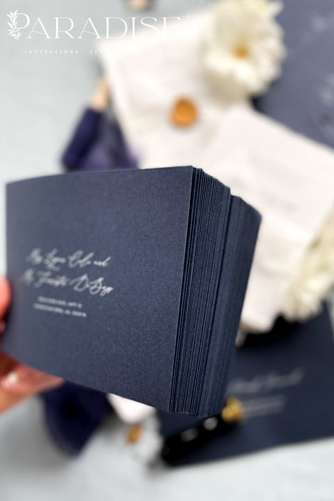 Stack of navy envelopes with address printing showing consistent color, structured paper stock, and polished presentation for luxury wedding stationery.