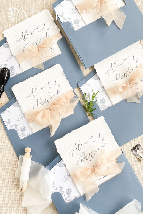 Bring timeless elegance to your celebration with our handmade deckled-edge wedding invitations, beautifully designed with dusty blue accents, soft chiffon ribbon, and a hand-drawn wedding venue illustration. Crafted for couples who value art, detail, and romance, each invitation is made by hand using premium cotton paper for a naturally textured, fine art finish. Perfect for fine art, garden, coastal, or destination weddings, this suite blends artisan craftsmanship with minimalist modern design.