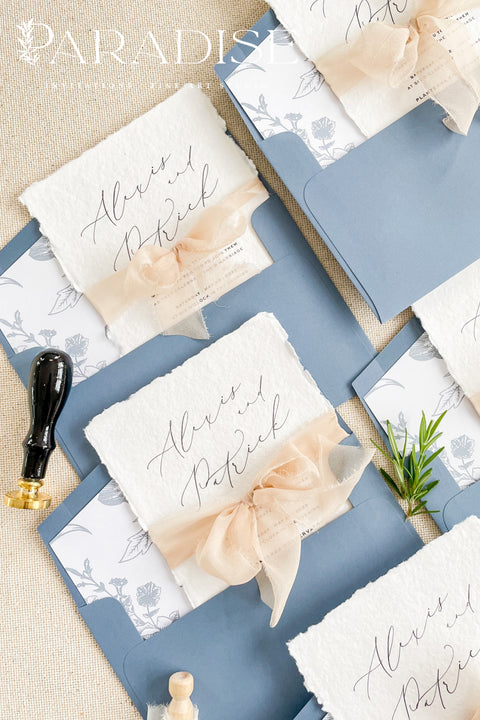 Bring timeless elegance to your celebration with our handmade deckled-edge wedding invitations, beautifully designed with dusty blue accents, soft chiffon ribbon, and a hand-drawn wedding venue illustration. Crafted for couples who value art, detail, and romance, each invitation is made by hand using premium cotton paper for a naturally textured, fine art finish. Perfect for fine art, garden, coastal, or destination weddings, this suite blends artisan craftsmanship with minimalist modern design.
