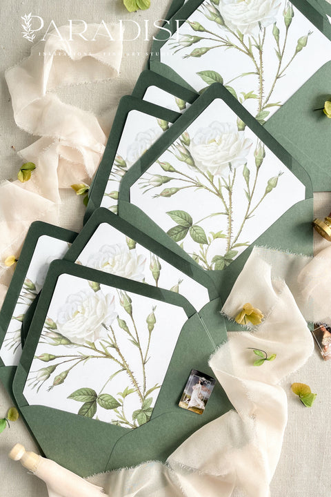 Soft green envelopes featuring floral liners, photographed open to reveal botanical artwork, ideal for elegant wedding invitations and fine-art stationery.