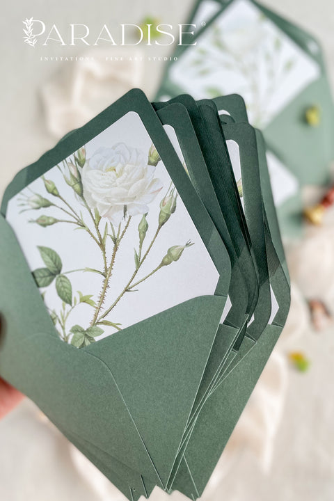 Soft green envelopes featuring floral liners, photographed open to reveal botanical artwork, ideal for elegant wedding invitations and fine-art stationery.