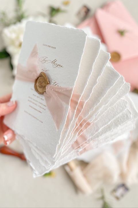 Celebrate your love story with our handmade paper Save the Date cards, thoughtfully designed for couples who cherish timeless elegance and artistry. Each card is printed on luxury 100% cotton handmade paper with softly torn deckled edges, wrapped in a delicate blush silk ribbon, and finished with a hand-pressed wax seal.