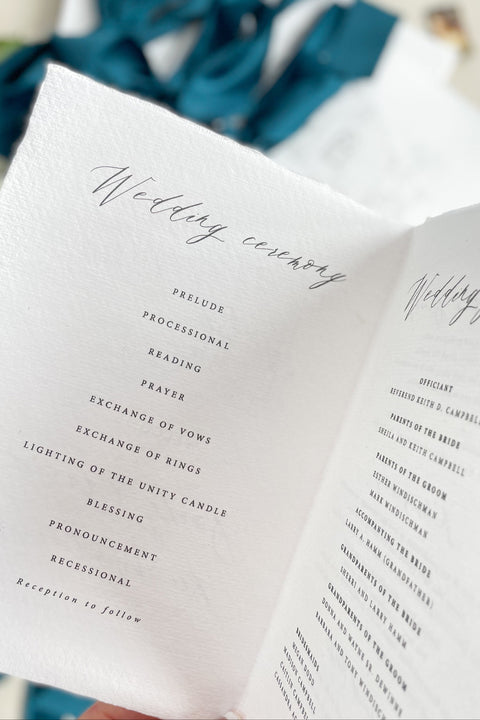 Hand-drawn venue artwork meets fine-art craftsmanship in these beautifully assembled wedding programs. The soft blue ribbon, textured cotton paper, and delicate illustration create an heirloom-quality piece that sets the tone for a romantic, detail-rich ceremony. Each program balances sophistication with warmth, offering guests a meaningful preview of your celebration.