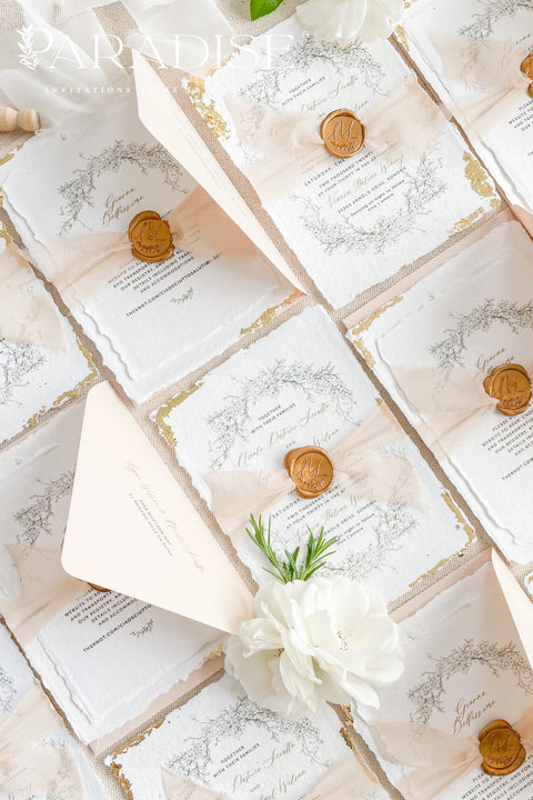 This exquisite wedding invitations suite offers a blend of timeless sophistication and eco-conscious elegance. Printed on premium, sustainable deckled edge fine art stationery, each invitation features a delicate golden leaf detail, adding a touch of luxurious shimmer. The suite is thoughtfully assembled with beautiful silk ribbons and sealed with a personalized wax seal, creating a stunning and tactile keepsake for your guests.