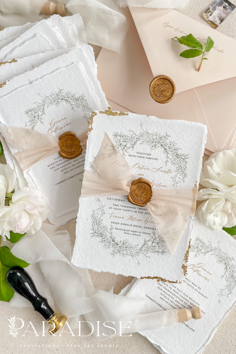 This exquisite wedding invitations suite offers a blend of timeless sophistication and eco-conscious elegance. Printed on premium, sustainable deckled edge fine art stationery, each invitation features a delicate golden leaf detail, adding a touch of luxurious shimmer. The suite is thoughtfully assembled with beautiful silk ribbons and sealed with a personalized wax seal, creating a stunning and tactile keepsake for your guests.