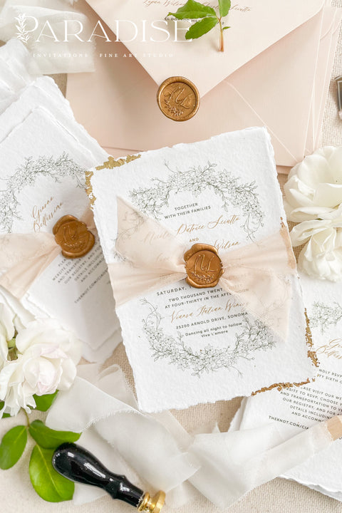 This exquisite wedding invitations suite offers a blend of timeless sophistication and eco-conscious elegance. Printed on premium, sustainable deckled edge fine art stationery, each invitation features a delicate golden leaf detail, adding a touch of luxurious shimmer. The suite is thoughtfully assembled with beautiful silk ribbons and sealed with a personalized wax seal, creating a stunning and tactile keepsake for your guests.