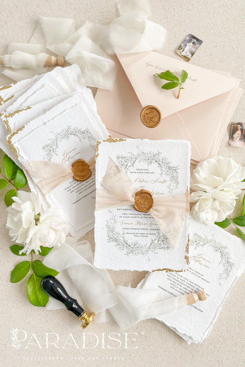 This exquisite wedding invitations suite offers a blend of timeless sophistication and eco-conscious elegance. Printed on premium, sustainable deckled edge fine art stationery, each invitation features a delicate golden leaf detail, adding a touch of luxurious shimmer. The suite is thoughtfully assembled with beautiful silk ribbons and sealed with a personalized wax seal, creating a stunning and tactile keepsake for your guests.