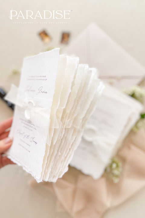 This exquisite wedding invites suite offers a blend of timeless sophistication and modern elegance. Designed with an eco-conscious approach, these luxury and timeless handmade invitations feature a beautiful modern calligraphy design and are printed on sustainable paper. The result is a truly unique and thoughtful suite that will leave a lasting impression on your guests.