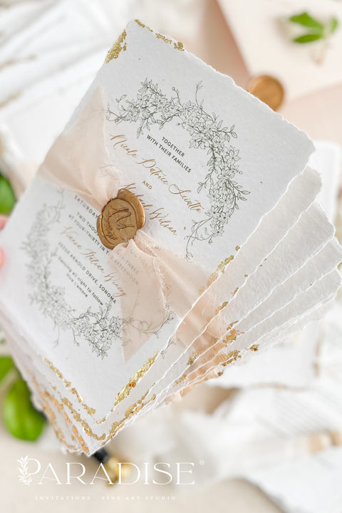 This exquisite wedding invitations suite offers a blend of timeless sophistication and eco-conscious elegance. Printed on premium, sustainable deckled edge fine art stationery, each invitation features a delicate golden leaf detail, adding a touch of luxurious shimmer. The suite is thoughtfully assembled with beautiful silk ribbons and sealed with a personalized wax seal, creating a stunning and tactile keepsake for your guests.