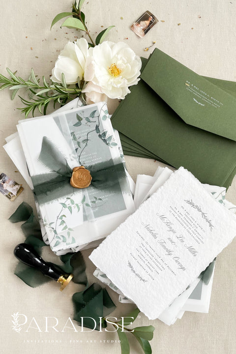 This handmade paper wedding invitation suite is designed for couples who cherish natural beauty and fine art craftsmanship. Each invitation is printed on luxury deckled-edge cotton paper, offering a rich, tactile texture that reflects the care and artistry poured into every detail. Encased in a botanical vellum jacket and hand-tied with a deep green silk ribbon and wax seal, this suite embodies organic elegance. It feels like a keepsake from nature itself - graceful, heartfelt, and timeless. 