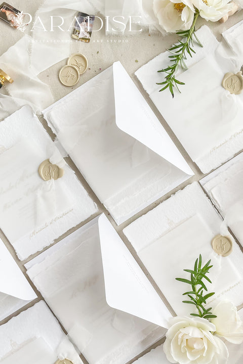 Announce your wedding with timeless elegance through our handmade deckled-edge wedding invitations, beautifully wrapped in vellum overlays, soft chiffon ribbons, and finished with custom gold wax seals. Each invitation is meticulously crafted by hand using luxury cotton paper, creating a textured, organic look that exudes romance and sophistication.