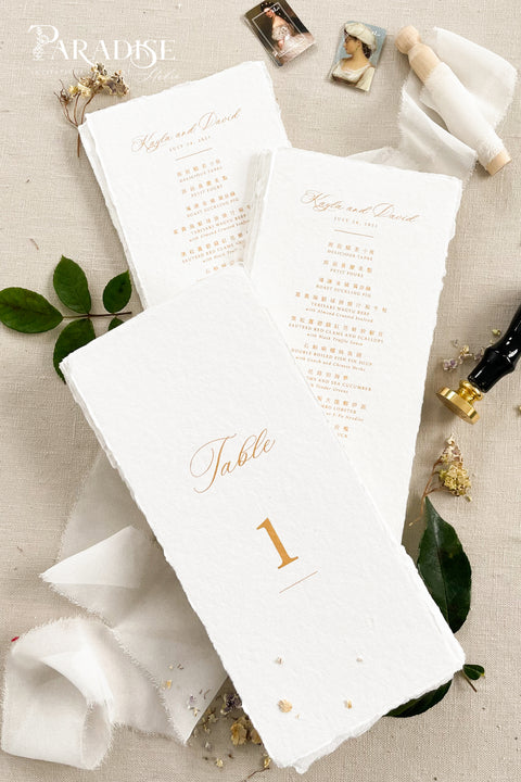 Add a touch of luxury and refinement to your reception with our handmade paper wedding menus in gold foil. Crafted from premium cotton paper with natural deckled edges, each menu radiates artisanal beauty and timeless elegance. The shimmering gold calligraphy and fine typography elevate your tablescape, making every setting look polished and romantic. 