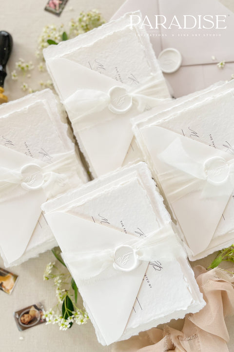 This exquisite wedding invites suite offers a blend of timeless sophistication and modern elegance. Designed with an eco-conscious approach, these luxury and timeless handmade invitations feature a beautiful modern calligraphy design and are printed on sustainable paper. The result is a truly unique and thoughtful suite that will leave a lasting impression on your guests.