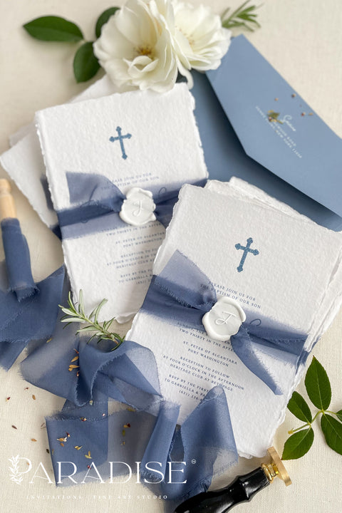 A beautifully handcrafted christening invitation designed to honor faith, tradition, and new beginnings. Made from luxurious handmade paper and finished with soft blue silk ribbon and a wax seal accent, this design features a delicate cross motif and refined typography. Perfect for baptisms and church ceremonies, it offers a timeless keepsake that reflects reverence and elegance.