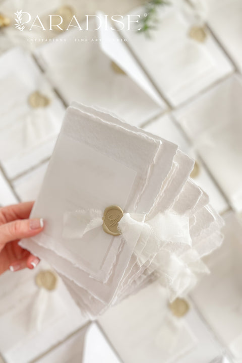 Announce your wedding with timeless elegance through our handmade deckled-edge wedding invitations, beautifully wrapped in vellum overlays, soft chiffon ribbons, and finished with custom gold wax seals. Each invitation is meticulously crafted by hand using luxury cotton paper, creating a textured, organic look that exudes romance and sophistication.