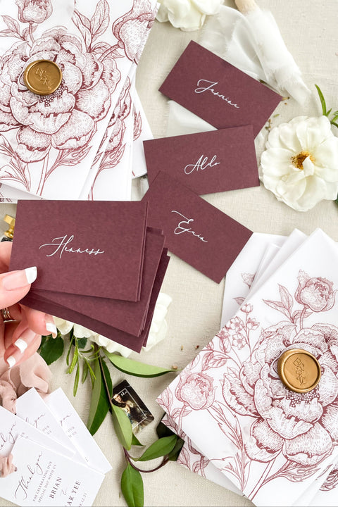 Make a bold, refined statement with our burgundy place cards, designed from premium heavyweight cardstock and finished with elegant calligraphy. Their rich, deep color adds dramatic sophistication to weddings, rehearsal dinners, galas, and modern celebrations. Whether styled with fine-art florals or paired with minimalist décor, these place cards bring effortless luxury, contrast, and warmth to any tablescape.