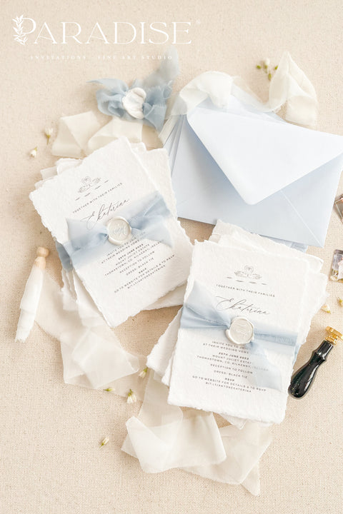 Delicate, timeless, and effortlessly romantic - this handmade paper wedding invitation suite is the perfect blend of fine art elegance and heartfelt simplicity. Printed on luxury deckled-edge cotton paper, each invitation exudes artisanal charm, its softly torn edges and tactile texture embodying the beauty of handcrafted design. Tied with a dusty blue silk ribbon and sealed with a white wax monogram, this suite radiates an ethereal calm - a whisper of something classic and pure. 