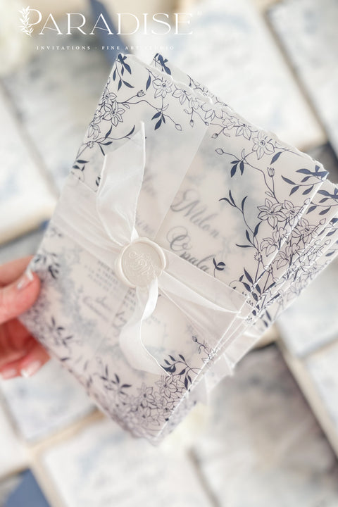 Celebrate your love with elegance and craftsmanship through our handmade blue fine art wedding invitations, featuring deckled-edge cotton paper, soft botanical designs, and luxurious vellum wraps tied with delicate silk ribbon and a custom wax seal. This suite combines timeless artistry with modern sophistication, perfect for coastal, fine art, or destination weddings seeking a romantic and refined aesthetic.