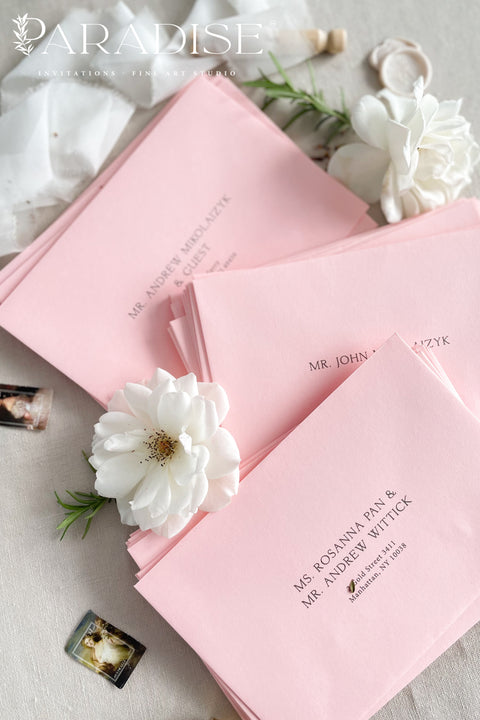 Dusty pink wedding envelopes with professional address printing, crafted from premium paper and styled to show soft color, smooth texture, and refined typography.