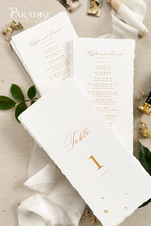 Add a touch of luxury and refinement to your reception with our handmade paper wedding menus in gold foil. Crafted from premium cotton paper with natural deckled edges, each menu radiates artisanal beauty and timeless elegance. The shimmering gold calligraphy and fine typography elevate your tablescape, making every setting look polished and romantic. 