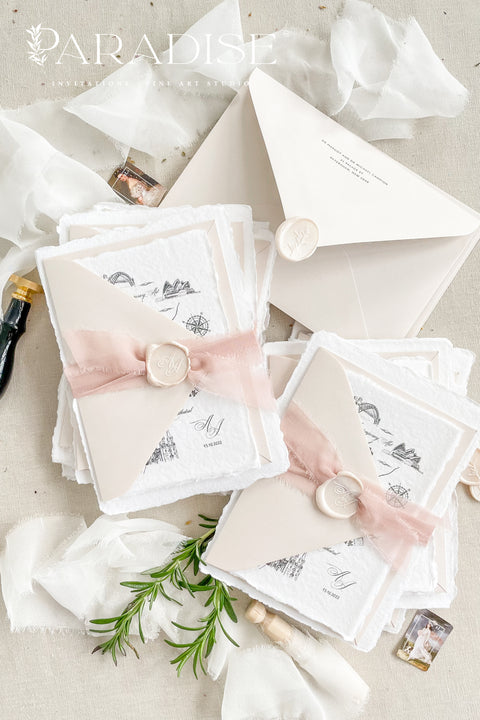 This handmade paper wedding invitation suite brings artistry and sentiment together. Each piece is printed on luxurious cotton paper with deckled edges, giving it a naturally soft and organic texture. The highlight of this suite is your custom hand-drawn map, created exclusively for your wedding to showcase your venue and key locations in elegant line art. Paired with blush silk ribbon, ivory envelopes, and a matching wax seal.