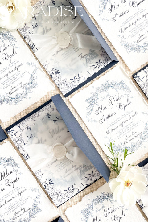 Celebrate your love with elegance and craftsmanship through our handmade blue fine art wedding invitations, featuring deckled-edge cotton paper, soft botanical designs, and luxurious vellum wraps tied with delicate silk ribbon and a custom wax seal. This suite combines timeless artistry with modern sophistication, perfect for coastal, fine art, or destination weddings seeking a romantic and refined aesthetic.