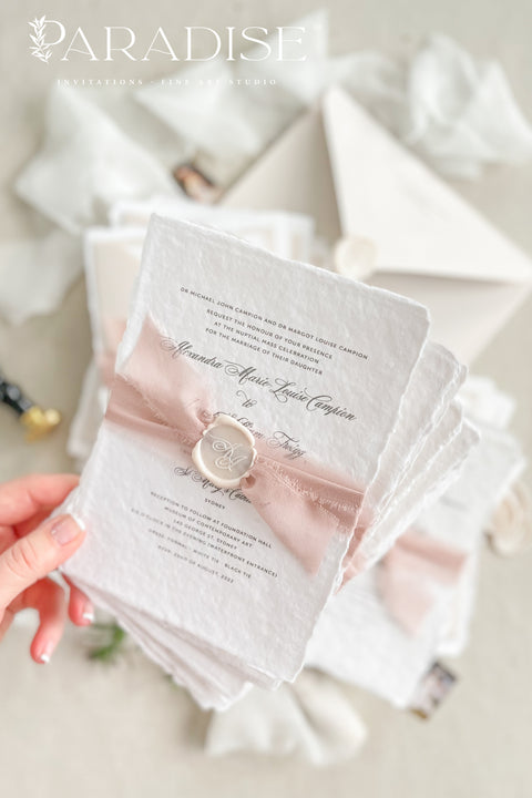 This handmade paper wedding invitation suite brings artistry and sentiment together. Each piece is printed on luxurious cotton paper with deckled edges, giving it a naturally soft and organic texture. The highlight of this suite is your custom hand-drawn map, created exclusively for your wedding to showcase your venue and key locations in elegant line art. Paired with blush silk ribbon, ivory envelopes, and a matching wax seal.
