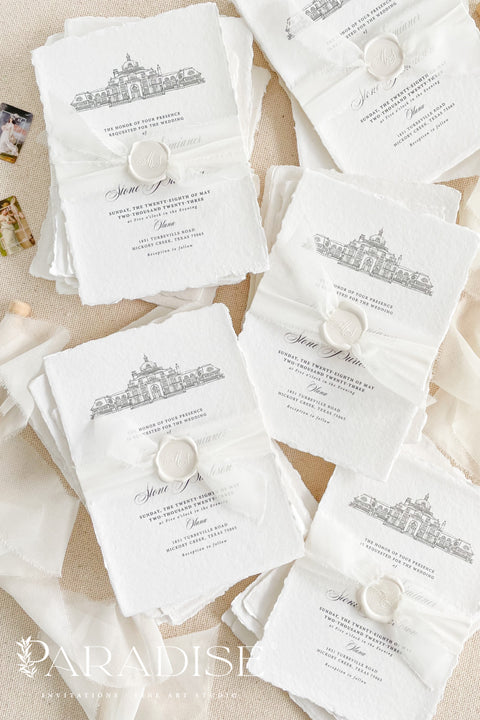 Our handmade wedding invitation suite features a custom hand-drawn illustration of your wedding venue, beautifully printed on luxury cotton paper with deckled edges. Each invitation is finished with a delicate wax seal and minimal fine art typography, creating a design that’s both classic and sophisticated. Soft textures, natural tones, and artisanal craftsmanship make it a perfect fit for estate, destination, or fine art weddings with a refined aesthetic.