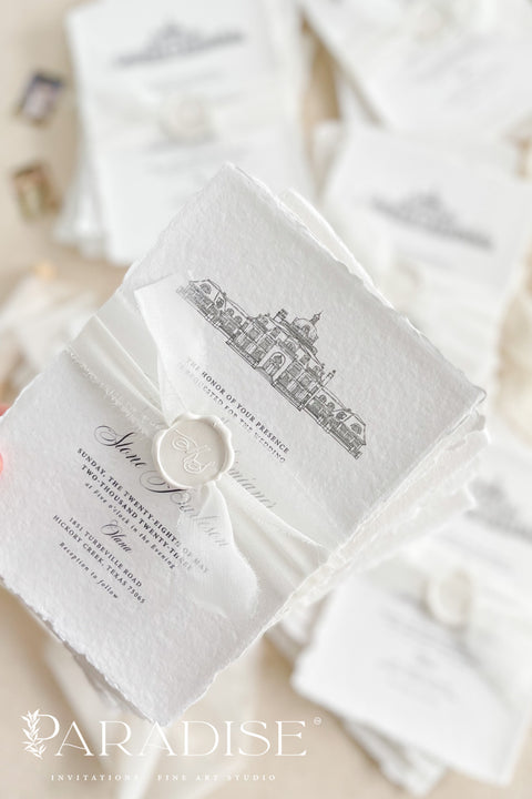 Our handmade wedding invitation suite features a custom hand-drawn illustration of your wedding venue, beautifully printed on luxury cotton paper with deckled edges. Each invitation is finished with a delicate wax seal and minimal fine art typography, creating a design that’s both classic and sophisticated. Soft textures, natural tones, and artisanal craftsmanship make it a perfect fit for estate, destination, or fine art weddings with a refined aesthetic.