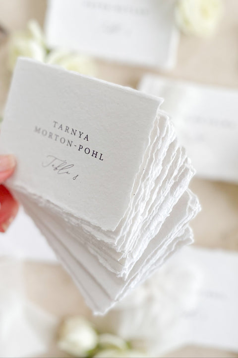 Add refined elegance to your seating display with our handmade paper place cards, crafted from luxurious cotton rag paper and finished with naturally torn deckled edges. Each card features minimalist typography paired with a soft fine-art aesthetic, making them perfect for weddings, intimate dinners, bridal showers, and elevated celebrations. With their organic texture and timeless look, these artisan-crafted cards bring sophistication and effortless beauty to any tablescape.