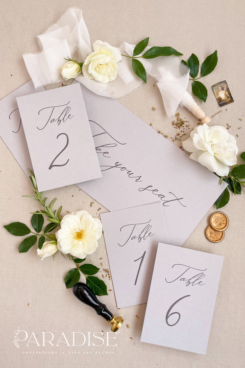 These minimalist table numbers feature clean typography, soft tones, and an elegant modern design, perfect for weddings seeking refined simplicity. Printed on premium cardstock with smooth, matte texture, each card elevates your reception tables with effortless style. Ideal for contemporary, classic, or romantic décor, these table numbers blend seamlessly with floral arrangements, candles, or fine-art tablescapes.