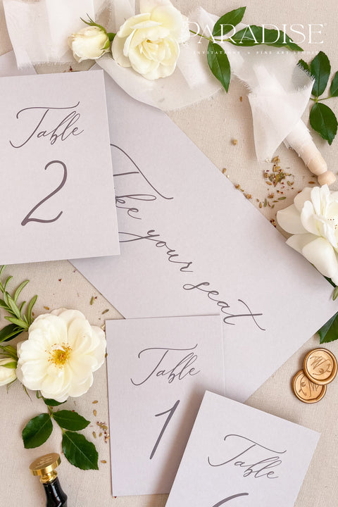 These minimalist table numbers feature clean typography, soft tones, and an elegant modern design, perfect for weddings seeking refined simplicity. Printed on premium cardstock with smooth, matte texture, each card elevates your reception tables with effortless style. Ideal for contemporary, classic, or romantic décor, these table numbers blend seamlessly with floral arrangements, candles, or fine-art tablescapes.