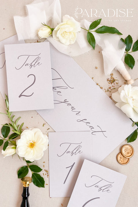 These minimalist table numbers feature clean typography, soft tones, and an elegant modern design, perfect for weddings seeking refined simplicity. Printed on premium cardstock with smooth, matte texture, each card elevates your reception tables with effortless style. Ideal for contemporary, classic, or romantic décor, these table numbers blend seamlessly with floral arrangements, candles, or fine-art tablescapes.