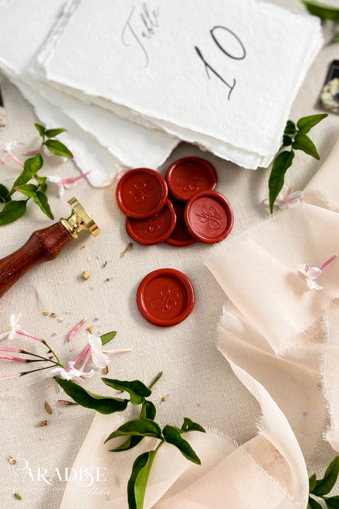 Rich in tone and timeless in character, these deep red wax seals add a classic finishing touch to wedding invitations, stationery suites, and heirloom keepsakes. Hand-poured in small batches, each seal features a smooth, slightly organic edge and a refined monogram impression that feels both traditional and intentional. Perfect for formal weddings, romantic designs, and vintage-inspired paper goods, these wax seals bring warmth, depth, and understated luxury to every detail.