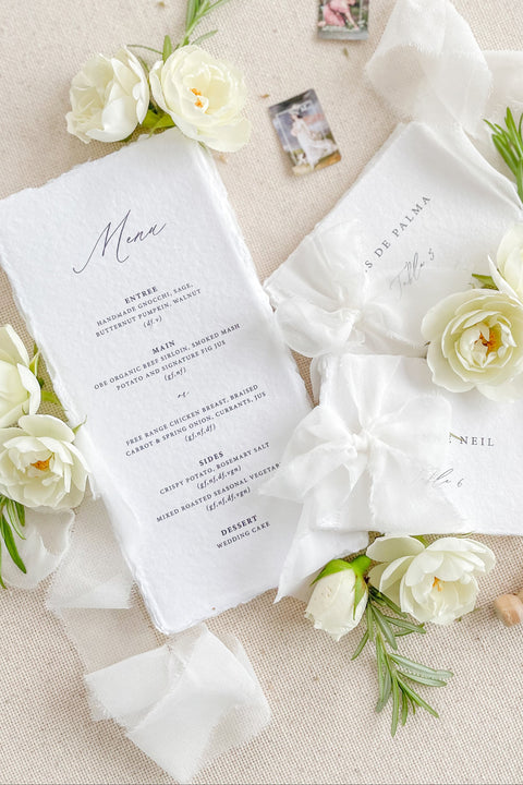Bring refined elegance to your tablescape with our handmade paper wedding menus, beautifully crafted with deckled edges and minimalist typography. Printed on luxurious cotton paper, each menu adds an artisanal, organic touch to your reception. Perfect for fine-art, coastal, and garden weddings, these menus exude timeless sophistication and natural charm.