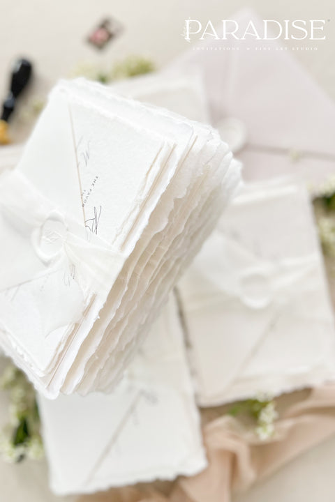 This exquisite wedding invites suite offers a blend of timeless sophistication and modern elegance. Designed with an eco-conscious approach, these luxury and timeless handmade invitations feature a beautiful modern calligraphy design and are printed on sustainable paper. The result is a truly unique and thoughtful suite that will leave a lasting impression on your guests.