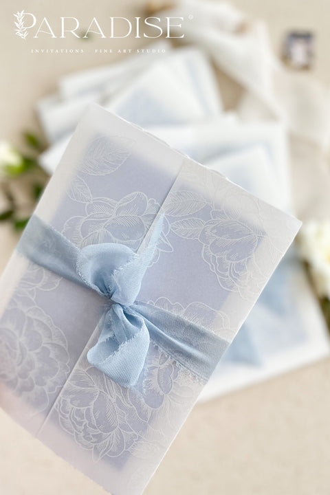 This exquisite wedding invitations suite offers a blend of coastal romance and bohemian charm. Perfect for a beach wedding, the invitations feature a delicate floral stationery design printed with crisp white ink on a translucent vellum jacket. The vellum wrap adds a touch of modern elegance and creates a beautifully layered look, perfectly complementing the carefree yet sophisticated vibe of this boho chic stationery.