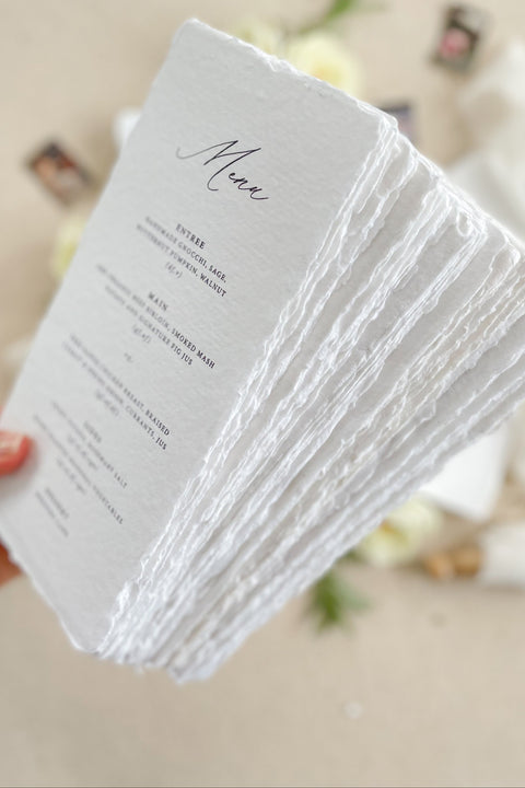 Bring refined elegance to your tablescape with our handmade paper wedding menus, beautifully crafted with deckled edges and minimalist typography. Printed on luxurious cotton paper, each menu adds an artisanal, organic touch to your reception. Perfect for fine-art, coastal, and garden weddings, these menus exude timeless sophistication and natural charm.