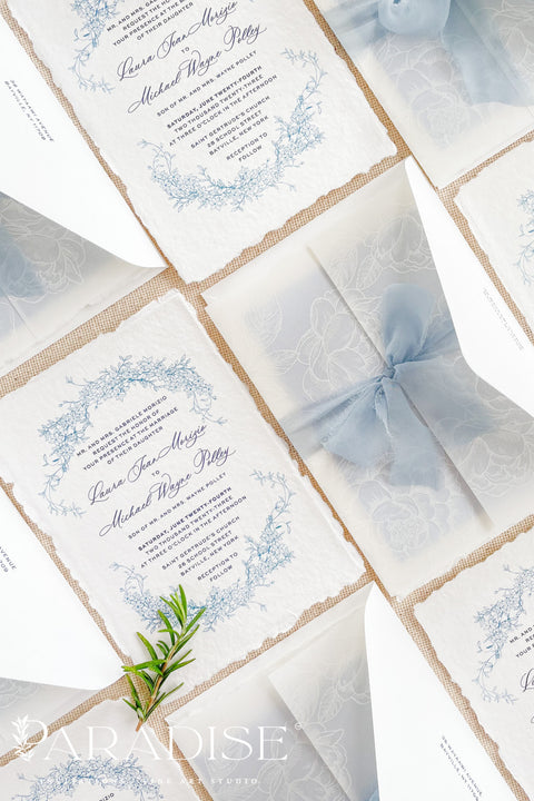 This exquisite wedding invitations suite offers a blend of coastal romance and bohemian charm. Perfect for a beach wedding, the invitations feature a delicate floral stationery design printed with crisp white ink on a translucent vellum jacket. The vellum wrap adds a touch of modern elegance and creates a beautifully layered look, perfectly complementing the carefree yet sophisticated vibe of this boho chic stationery.