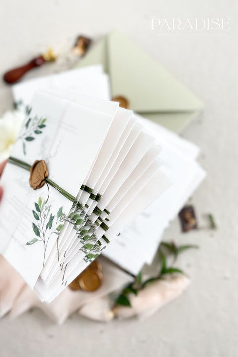 This botanical wedding invitation suite embodies effortless sophistication. Printed on luxury deckled-edge cotton paper, each piece is adorned with a delicate botanical motif and your custom monogram, creating a beautiful balance of refinement and intimacy. Wrapped in a vellum jacket featuring soft greenery details and tied with an olive silk ribbon, this suite exudes quiet romance - the kind inspired by nature, craftsmanship, and heartfelt storytelling.