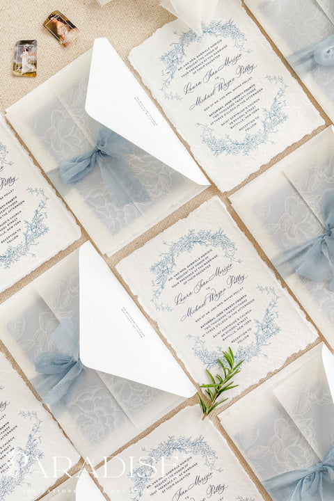 This exquisite wedding invitations suite offers a blend of coastal romance and bohemian charm. Perfect for a beach wedding, the invitations feature a delicate floral stationery design printed with crisp white ink on a translucent vellum jacket. The vellum wrap adds a touch of modern elegance and creates a beautifully layered look, perfectly complementing the carefree yet sophisticated vibe of this boho chic stationery.