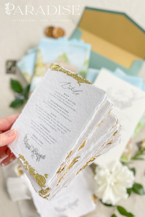 Announce your wedding with timeless artistry through this letterpress wedding invitation suite, featuring a custom watercolor vellum jacket that beautifully captures the romance of your venue. Each invitation is hand-pressed on luxury cotton paper, its deep letterpress impressions paired with soft deckled edges to evoke the elegance of fine art stationery. The suite is wrapped in a vellum overlay adorned with a watercolor venue illustration, sealed with a warm gold wax emblem.